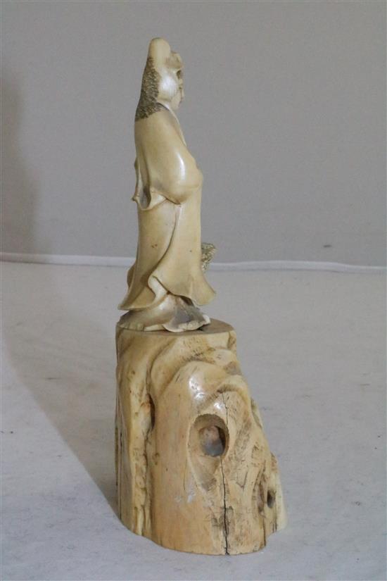 A Japanese ivory figure of Kwannon standing on rockwork, early 20th century, 14.5cm